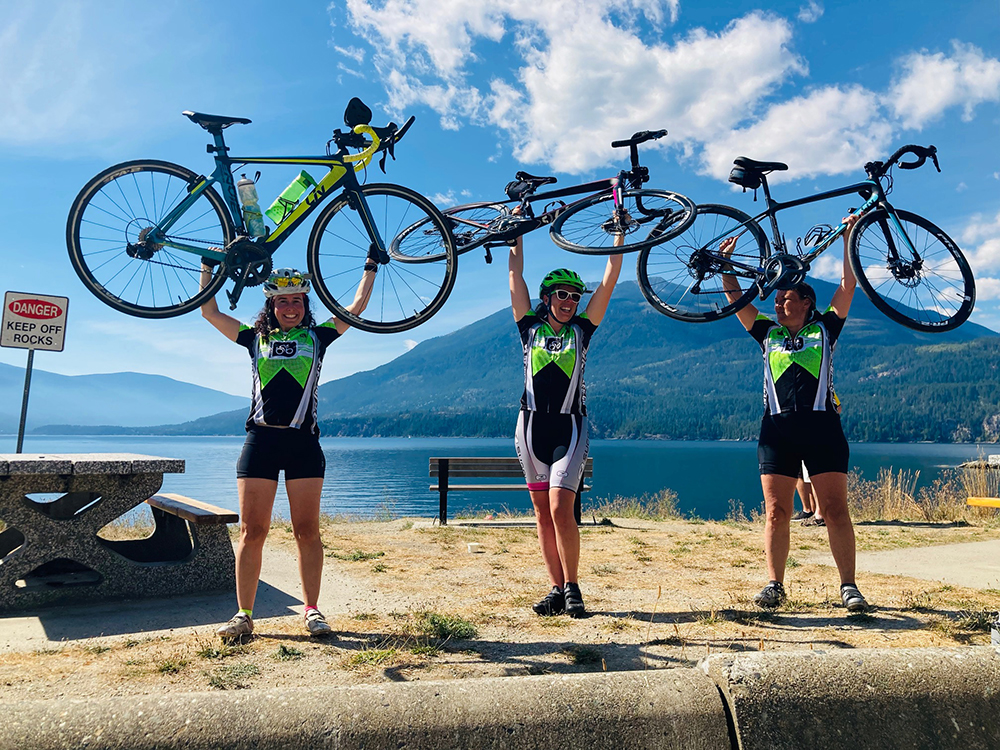 cyclists raising their bicycles