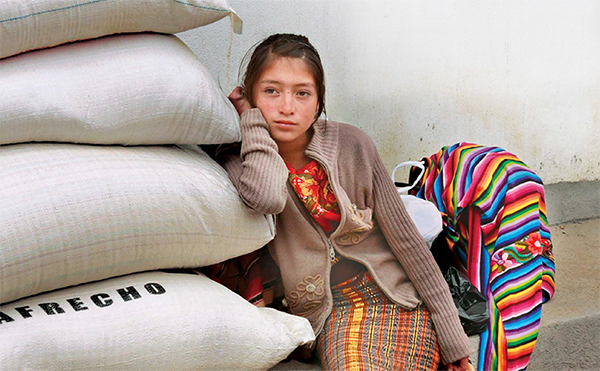 Girl leaning on a pile of sacks