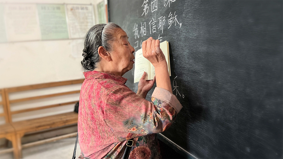 Chinese woman writing on a board