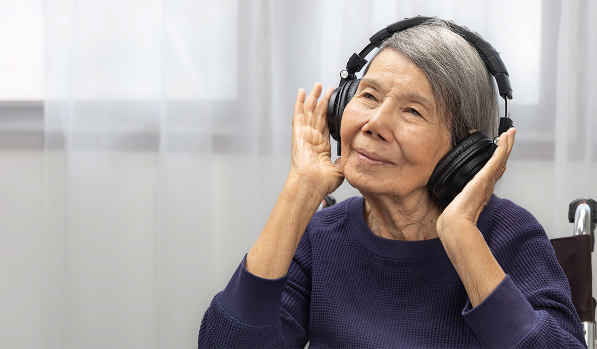 Elderly woman with headphones