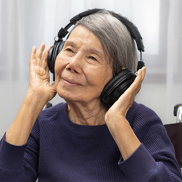 Elderly woman with headphones