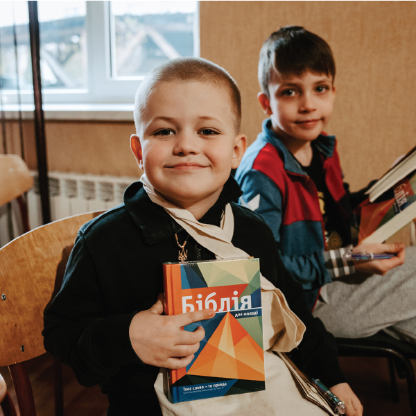 Ukrainian children holding Scriptures for children